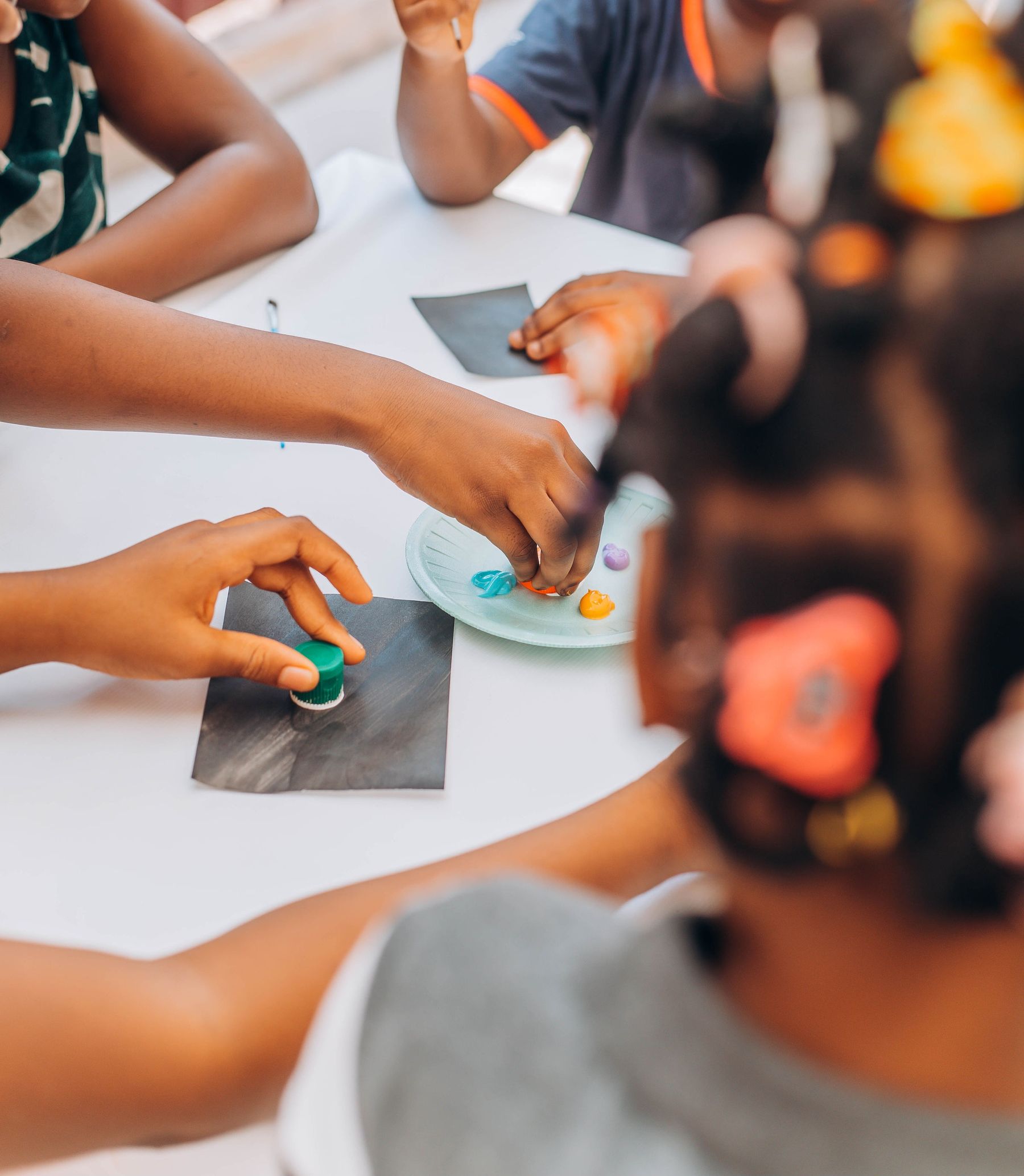 Young children creating together during a collaborative art experience