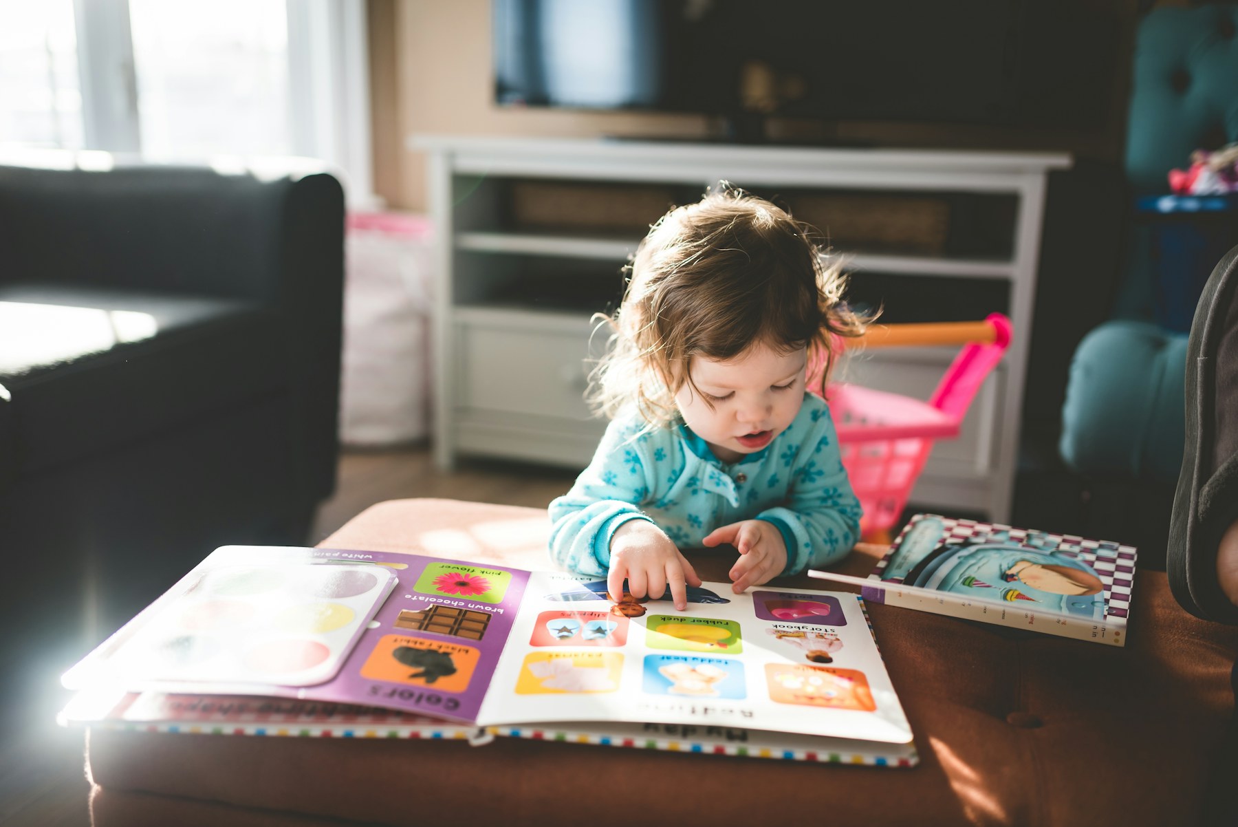 An educator sharing a storybook learning moment with young children